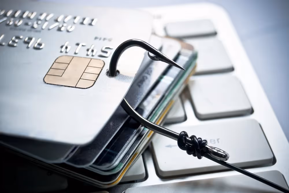 a silver credit card with a black cable