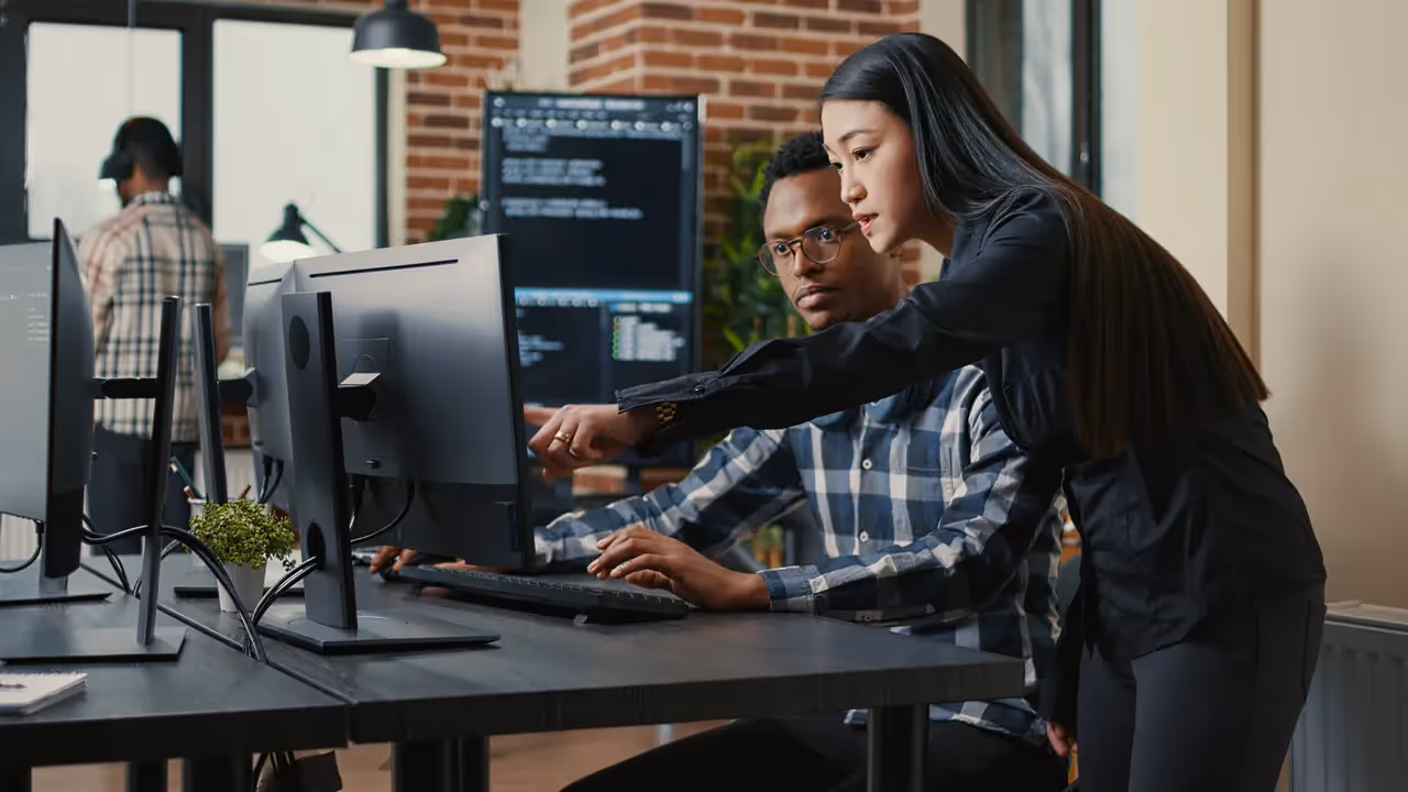 a woman sitting at a desk with a computer