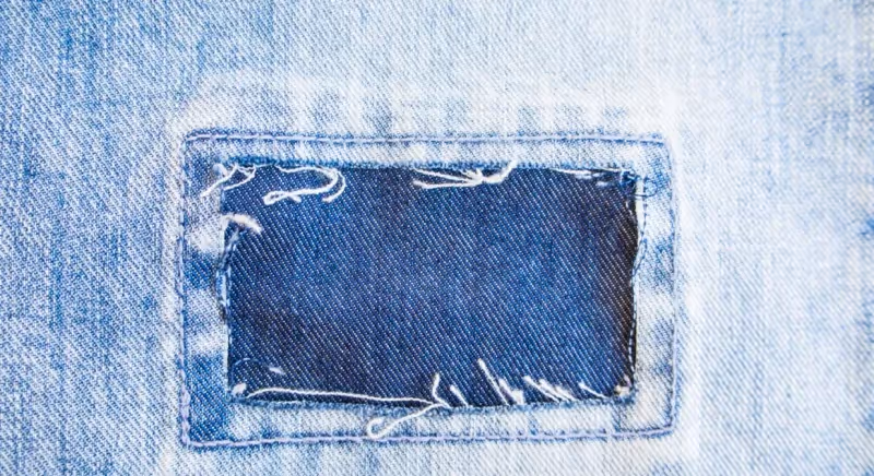 a piece of blue denim with a hole in the middle