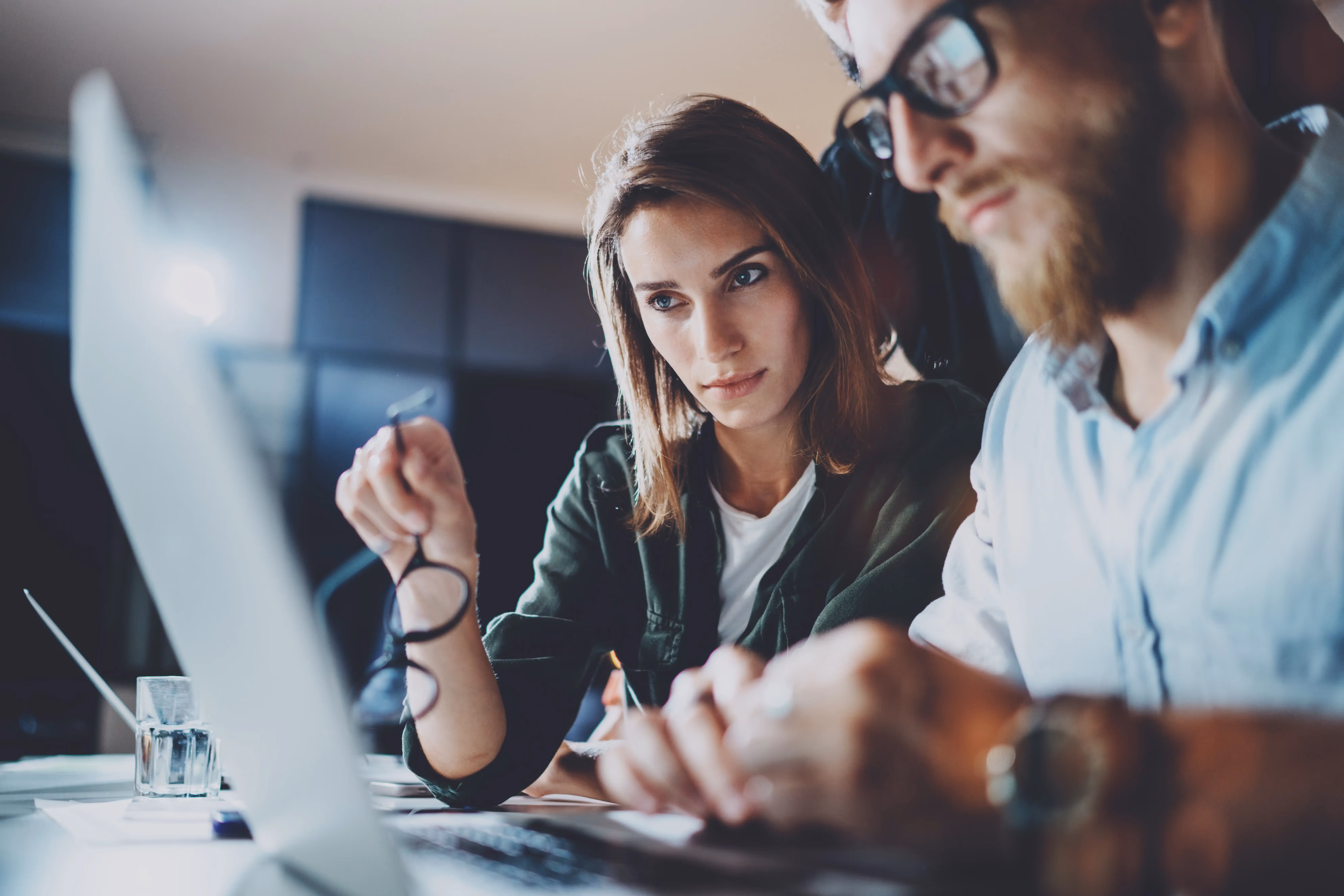 man and women looking at laptop