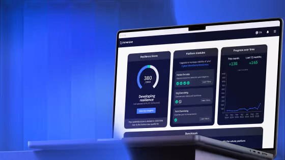 Laptop screen showing resilience score, platform modules, and progress on a cyber resilience dashboard.