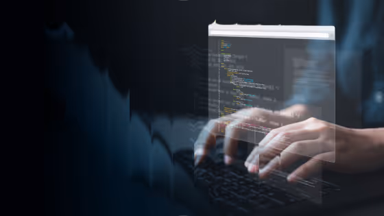 Hands typing on a laptop keyboard with translucent coding windows floating above in a dark environment.