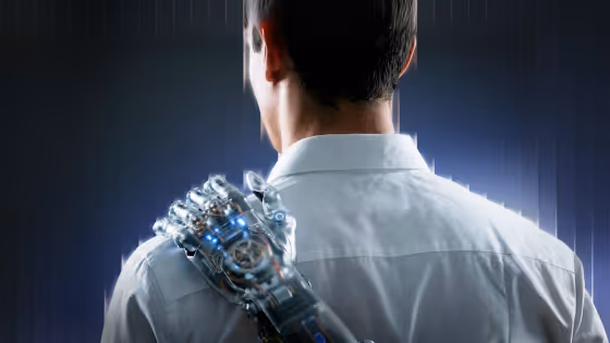 Back view of a man in a white shirt with a robotic hand on his shoulder glowing blue lights.