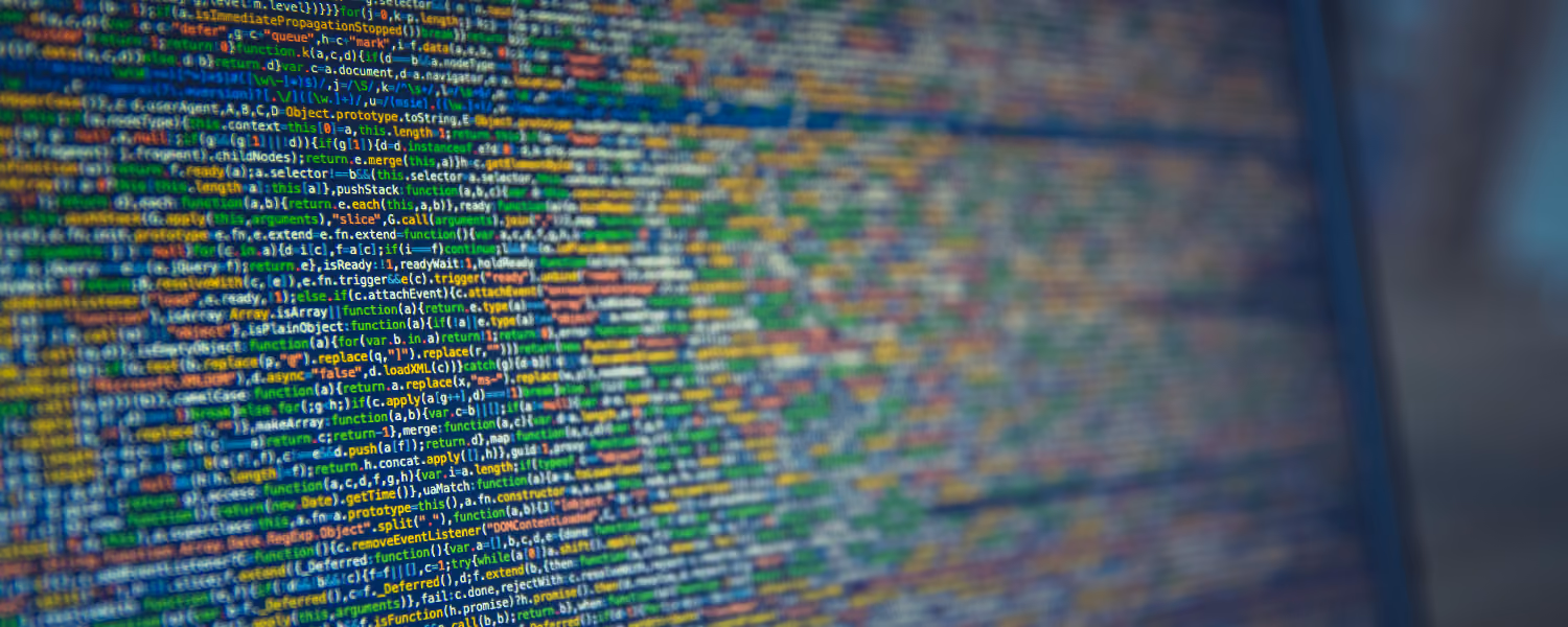 Close-up of colorful programming code displayed on a computer screen with a blurred background.