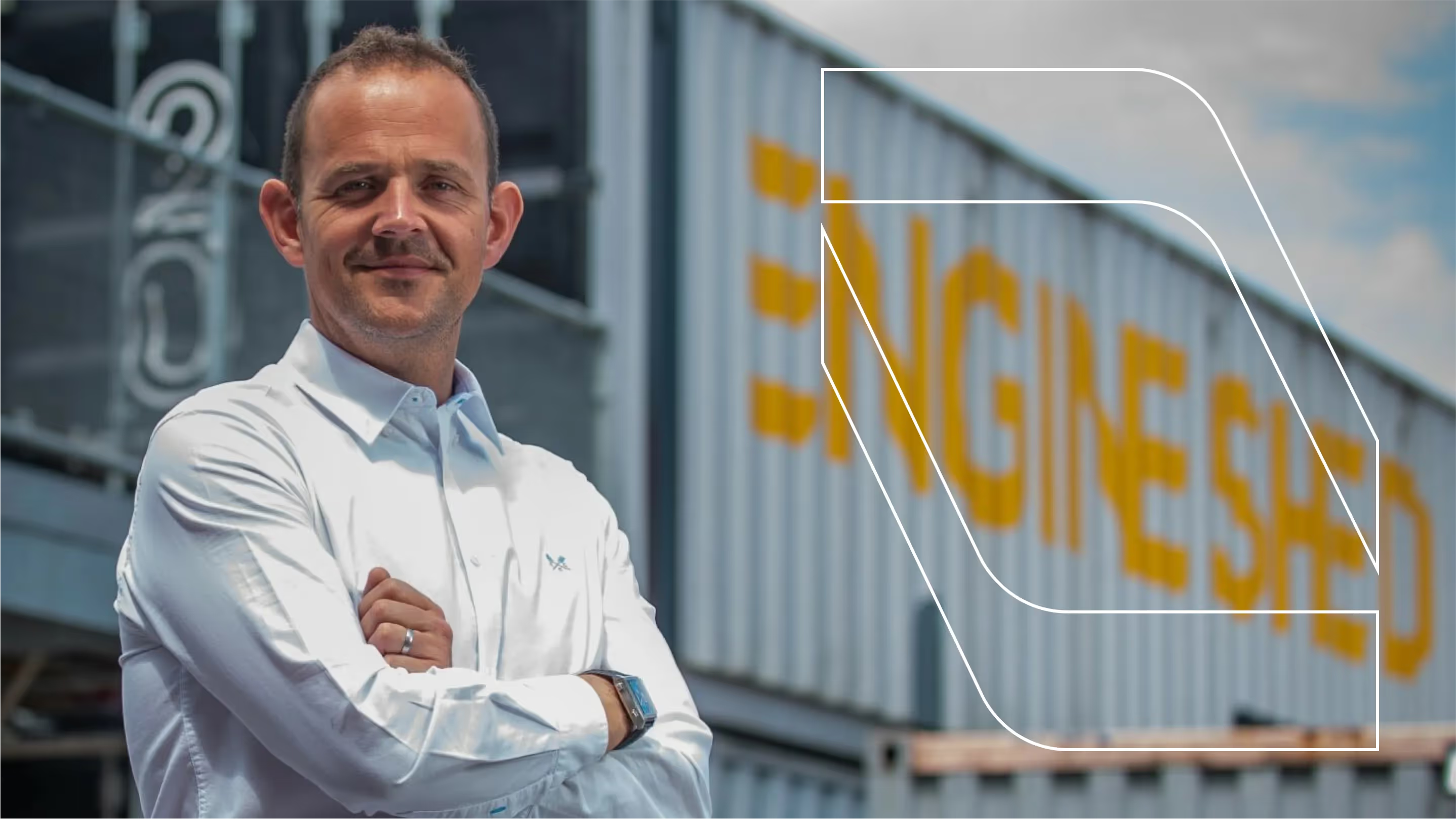 Man standing with folded arms outside an Immersive shipping container.