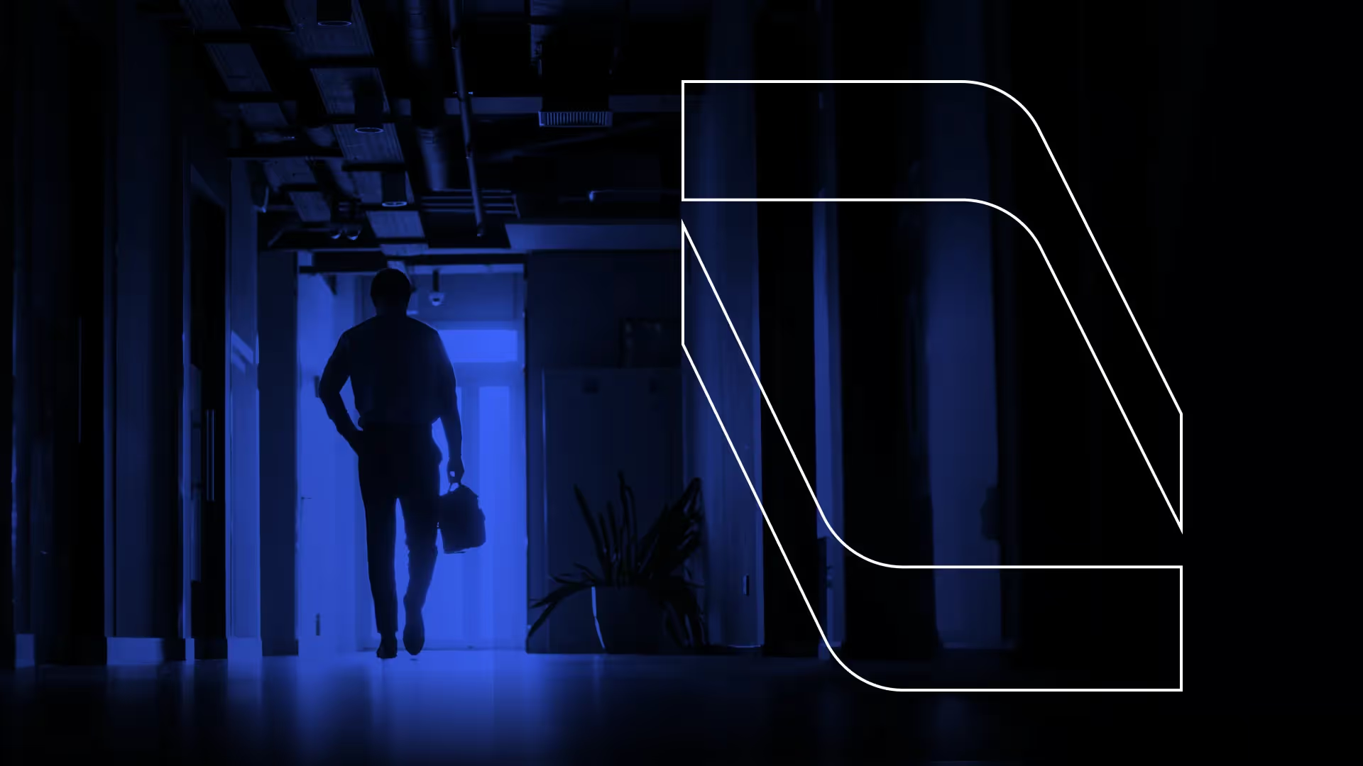 Silhouette of a person walking down a dimly lit hallway holding a briefcase.