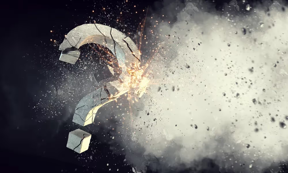 Question mark breaking apart into fragments and dust.