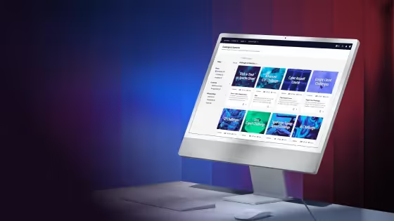 Desktop computer showing a platform with categories and services on screen with blue and red gradient background.