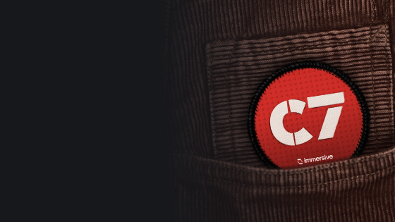 Red round badge with white letters 'C7' in a brown corduroy shirt pocket.
