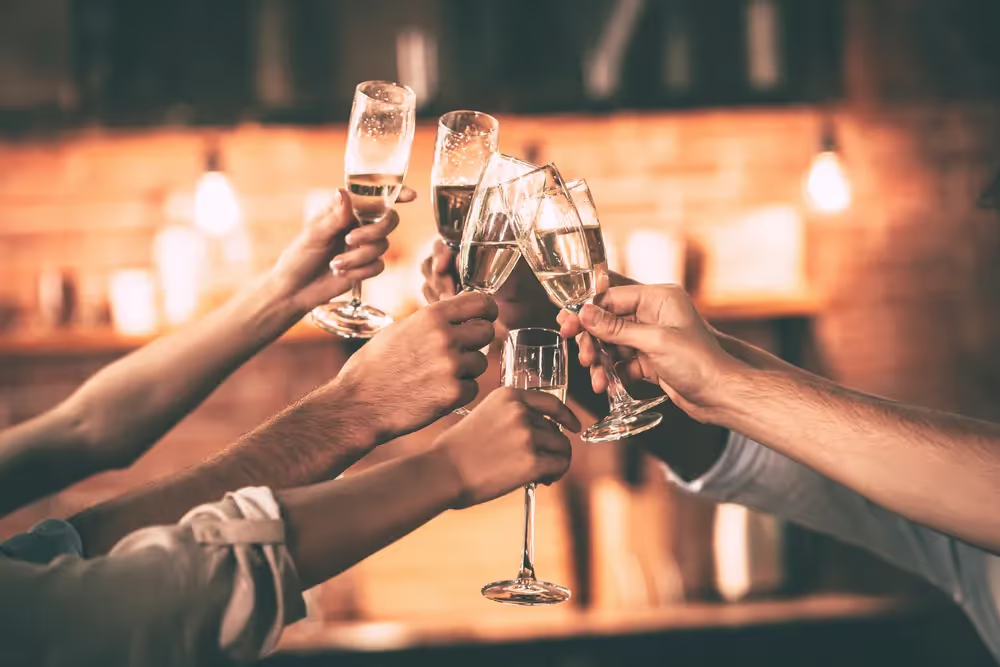 People raising champagne glasses in a toast.