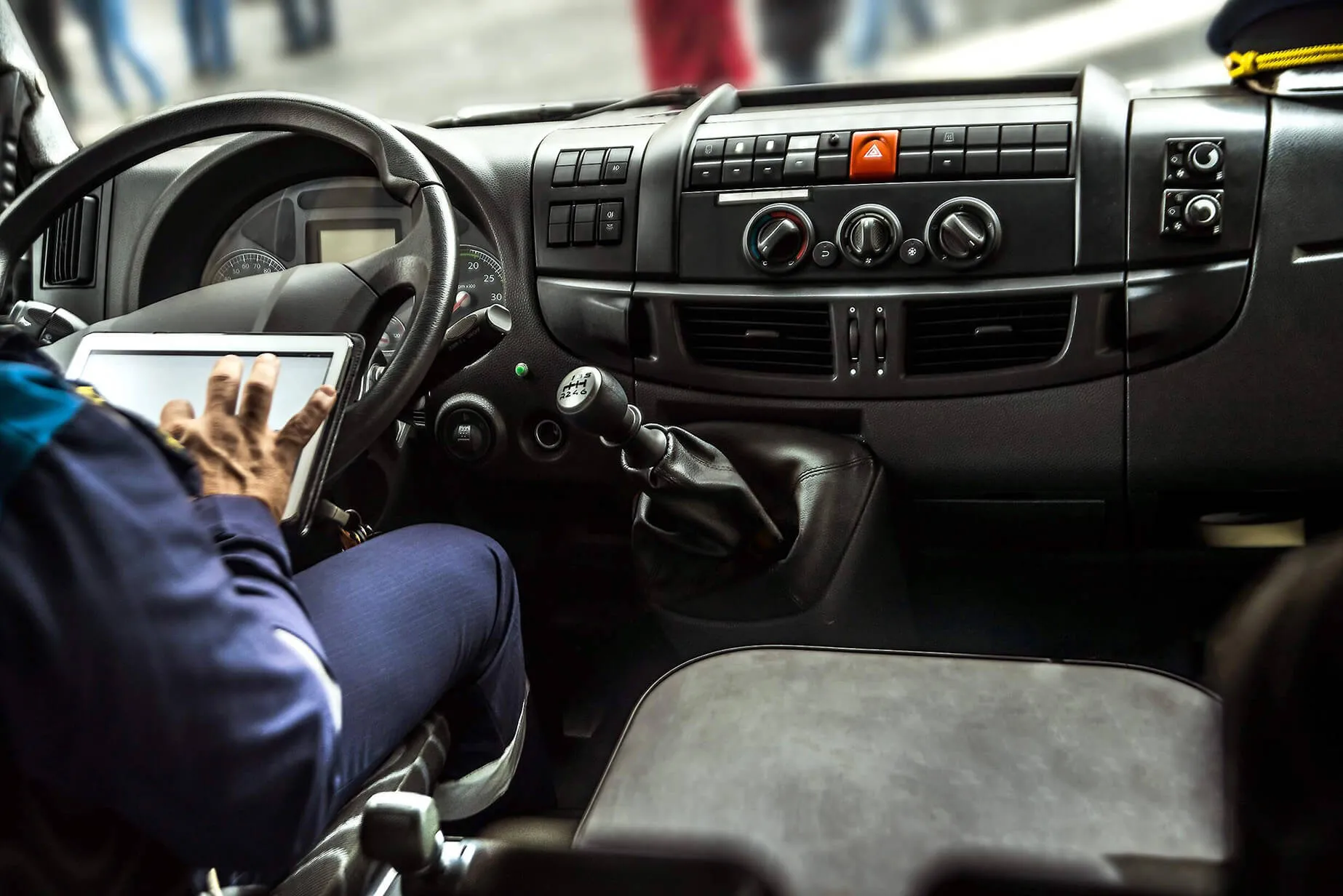 Person in van accessing telematics on tablet