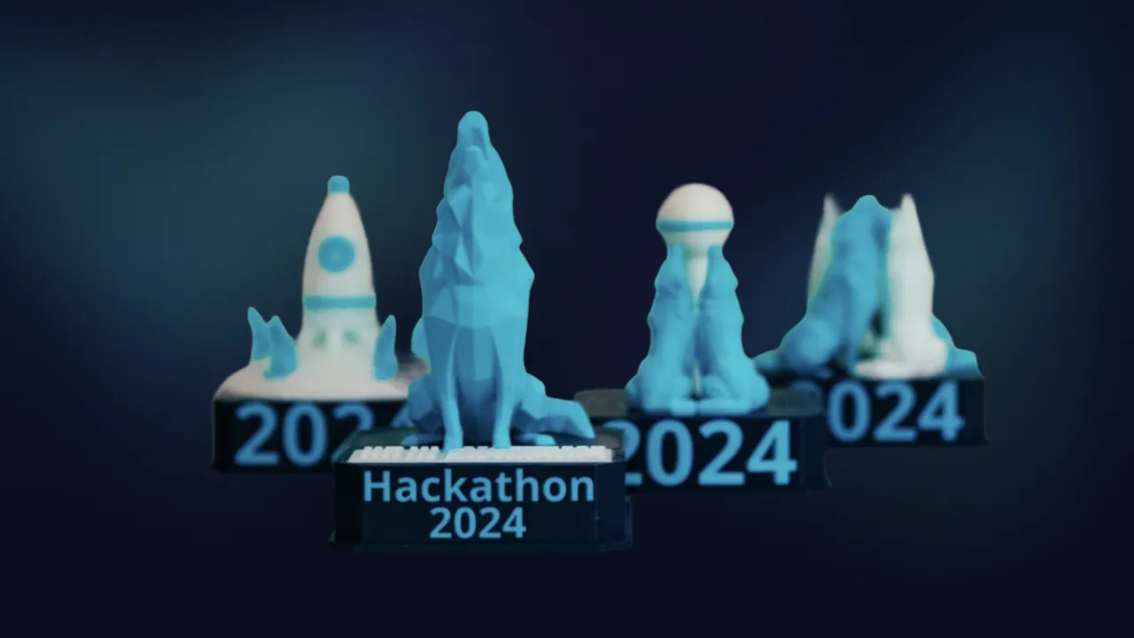 3D-printed Hackathon 2024 trophies shaped like wolves and a rocket on a dark blue background