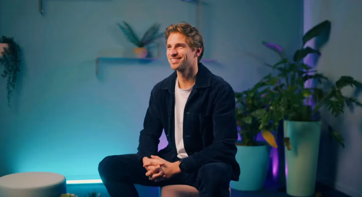 Mathieu seated in a plant-filled studio during a filmed interview at TechWolf