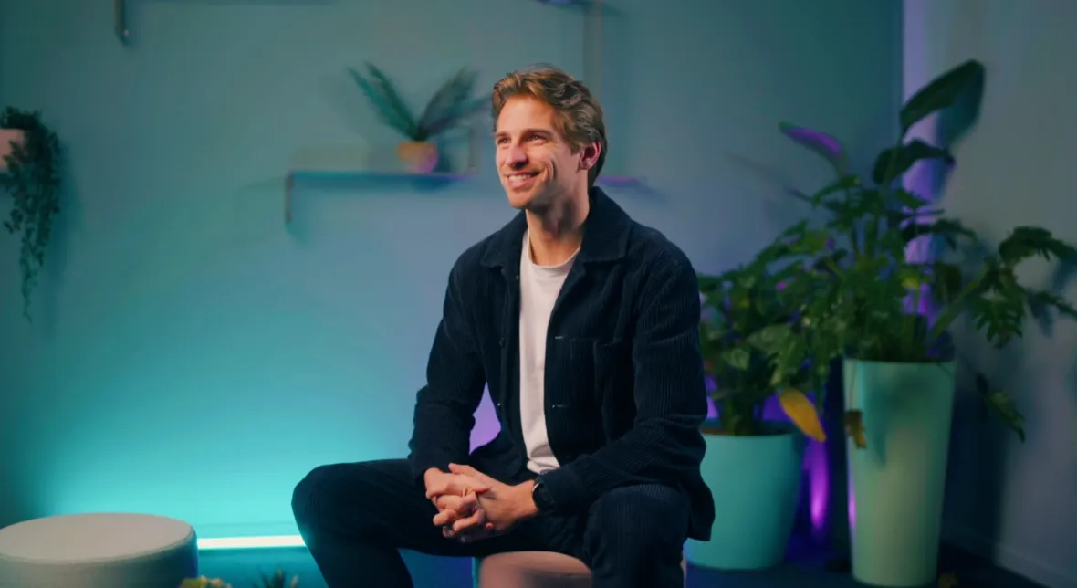 Mathieu seated in a plant-filled studio during a filmed interview at TechWolf