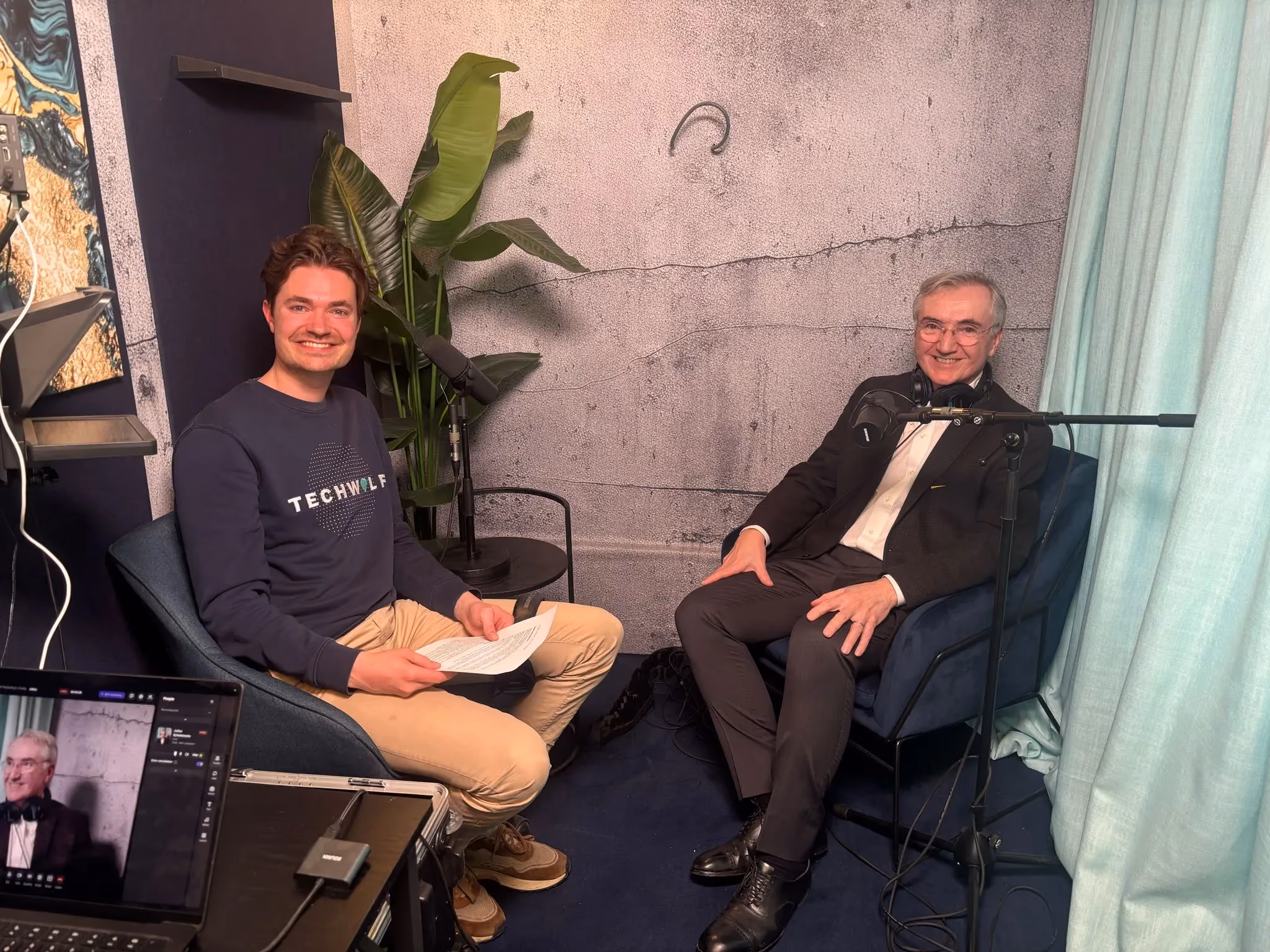 Podcast recording with a TechWolf host and guest Joseph Fuller seated in a studio