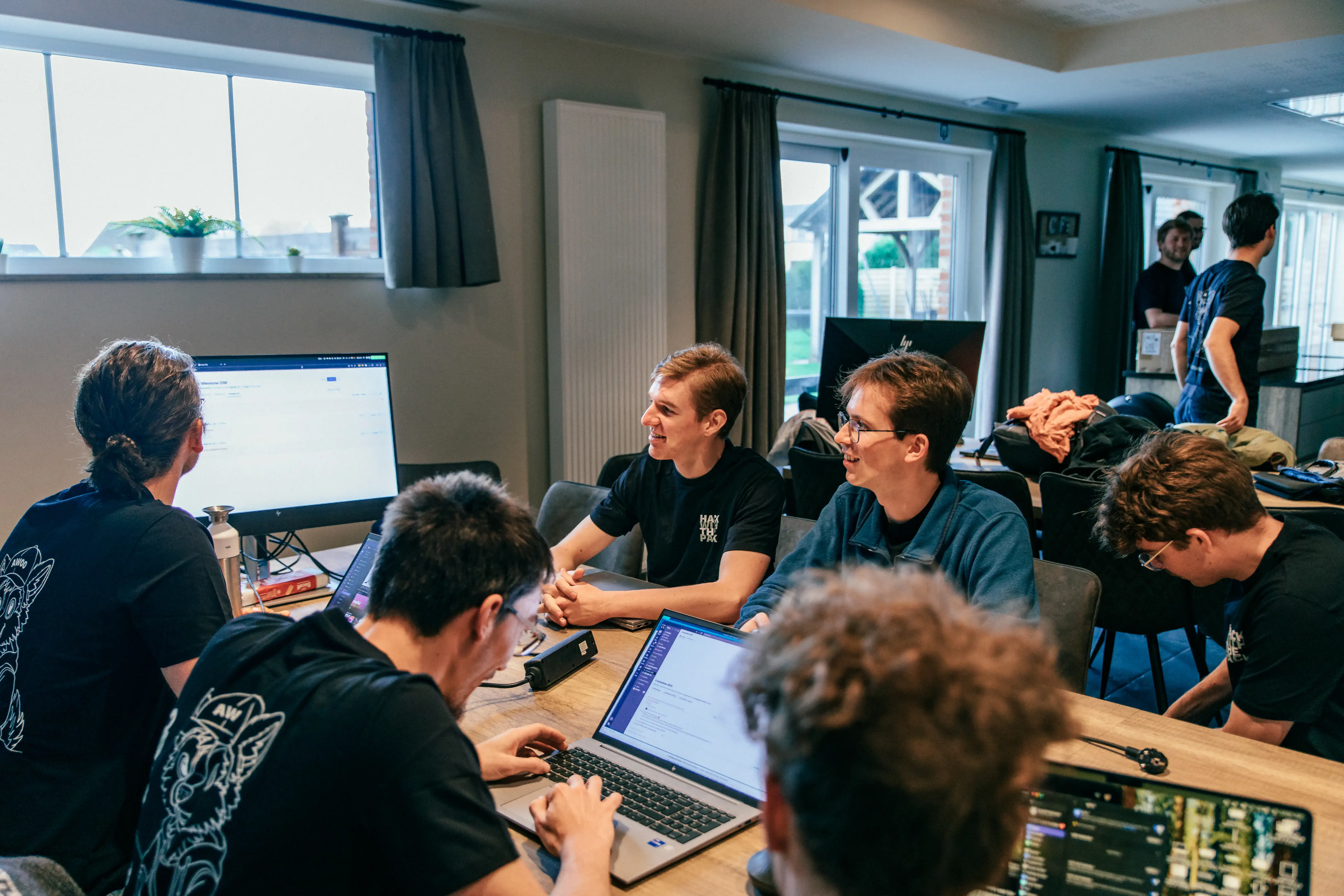TechWolf engineers working together around a table during the hackathon