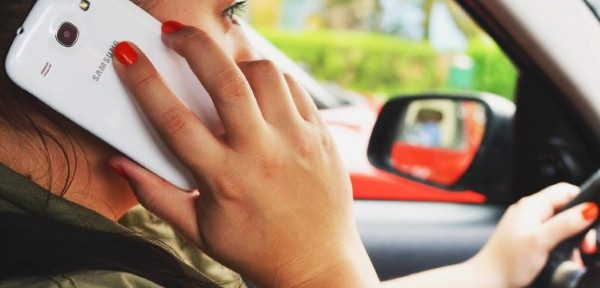 Woman using phone while driving