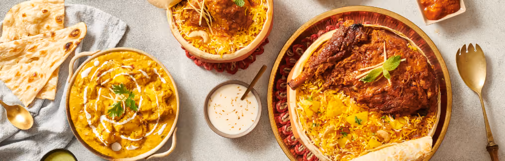 An overhead shot of a feast with Indian dishes incluAn overhead shot of a feast with Indian dishes