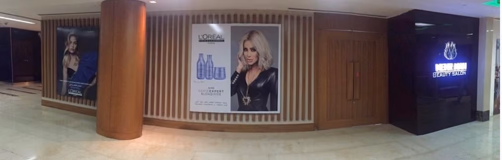 Exterior view of a Mona Mona Beauty Salon entrance with L'Oréal Professionnel advertisements