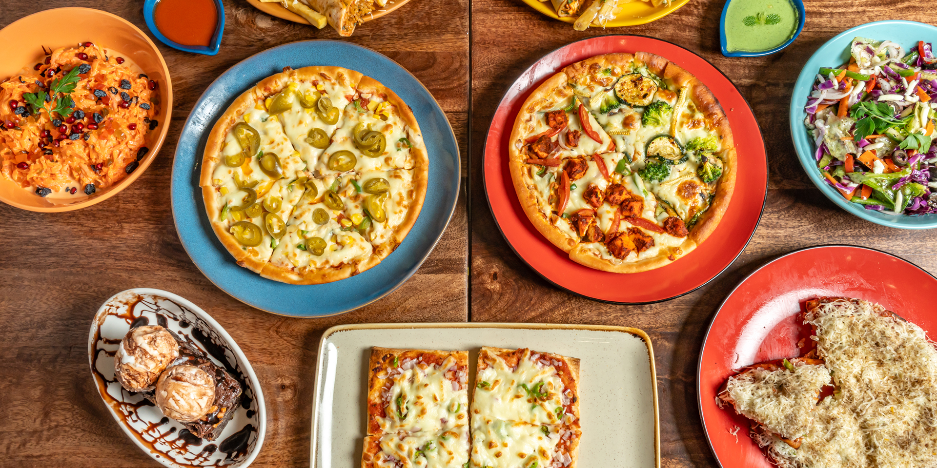 a serving of stuffed parathas with side dishes of chole and dal