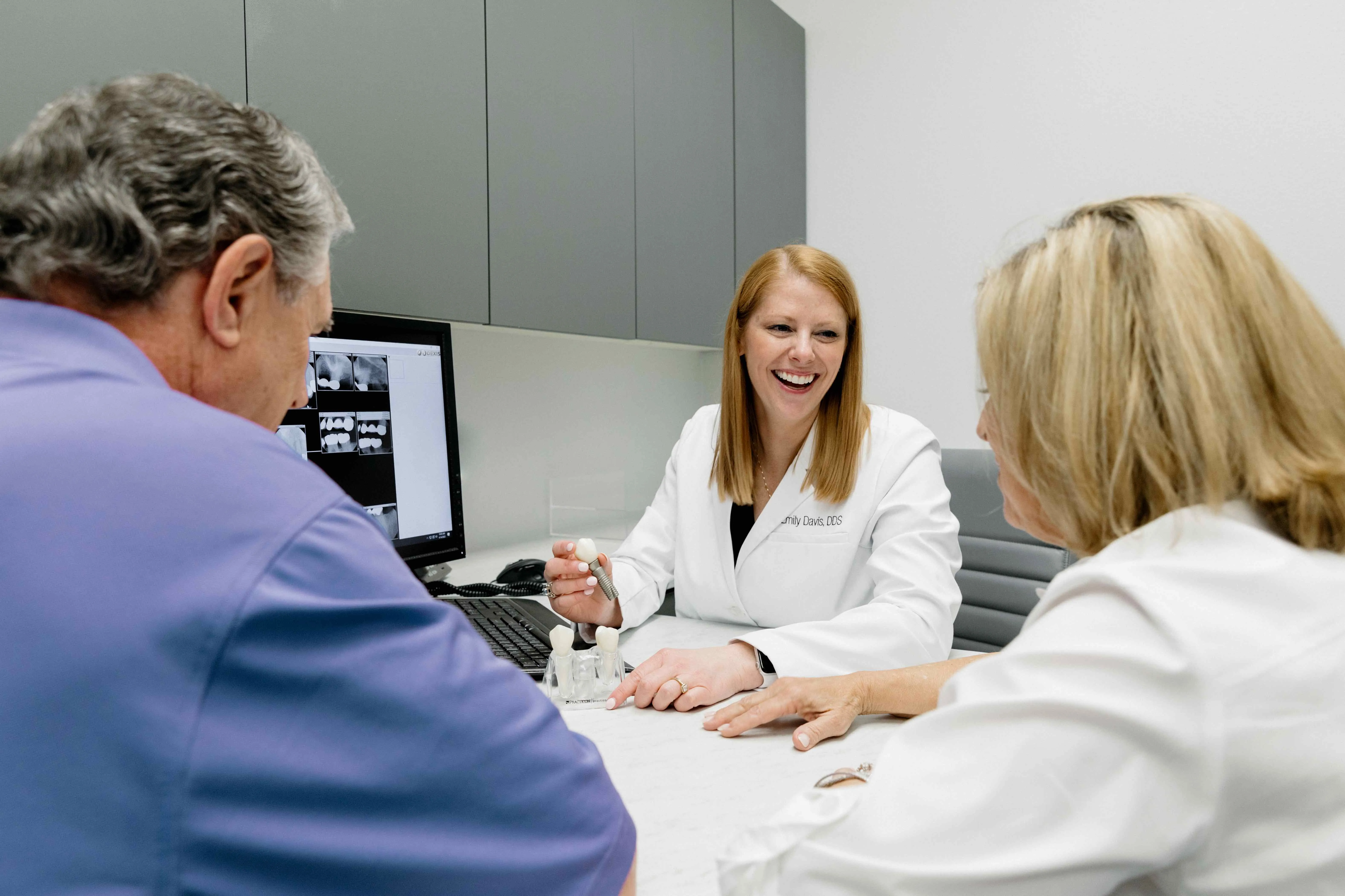 Dr Davis  explaining to a patient how dental implants work