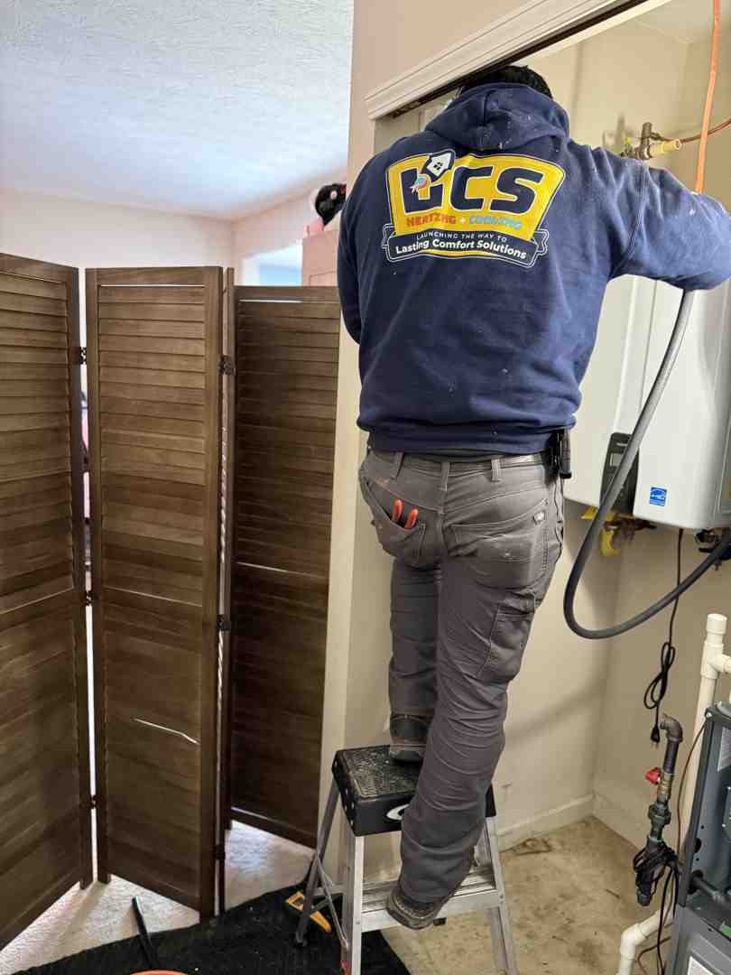 a homeowner talking with a friendly HVAC technician - professional furnace installation in carmel, in