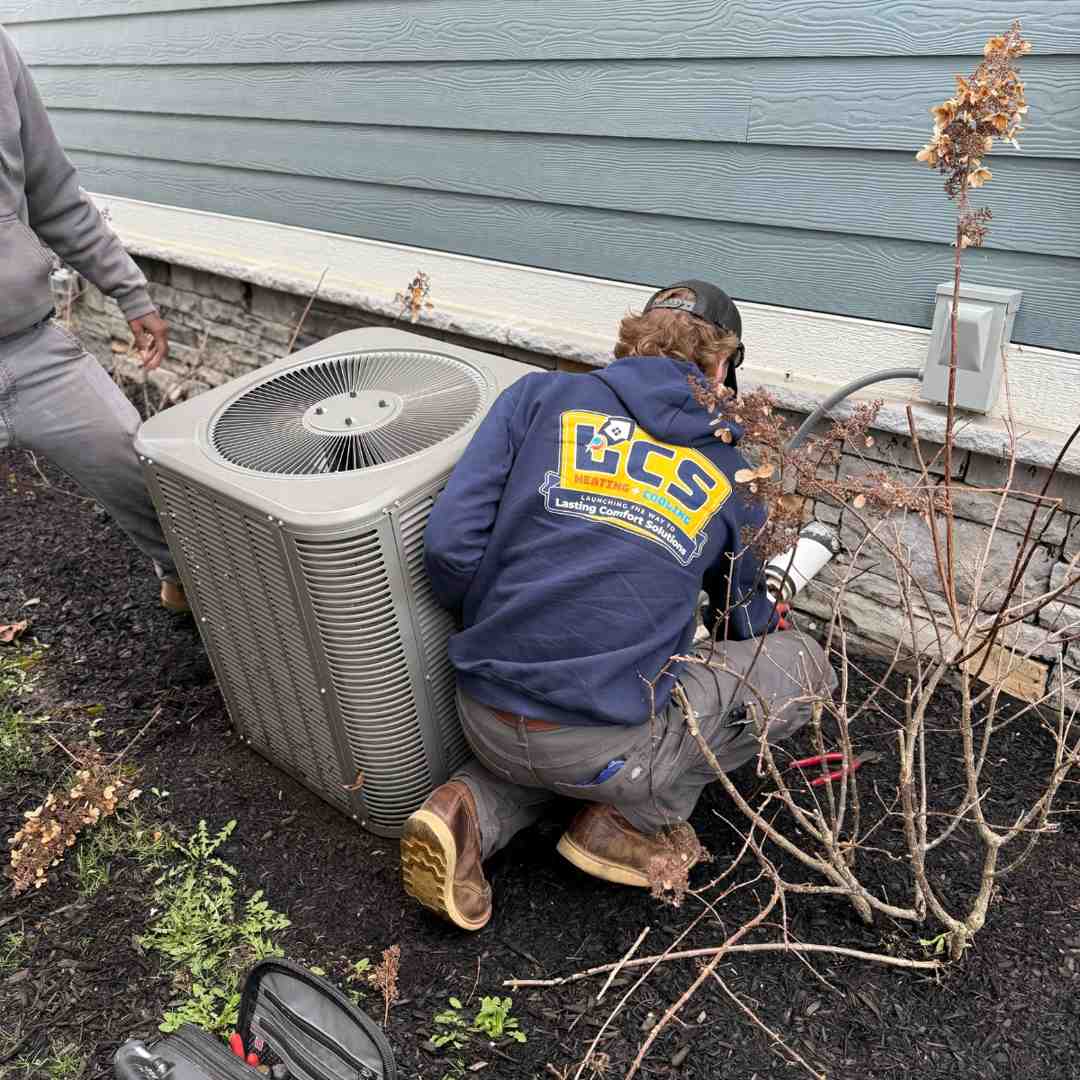 a technician performing maintenance on a heat pump - best heat pump maintenance in noblesville, in a technician performing maintenance on a heat pump - best heat pump maintenance in noblesville, in