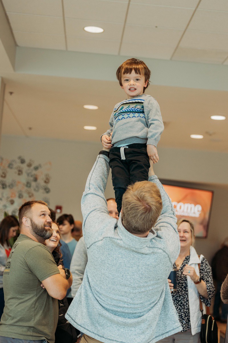 People of multiple generations worshipping together.