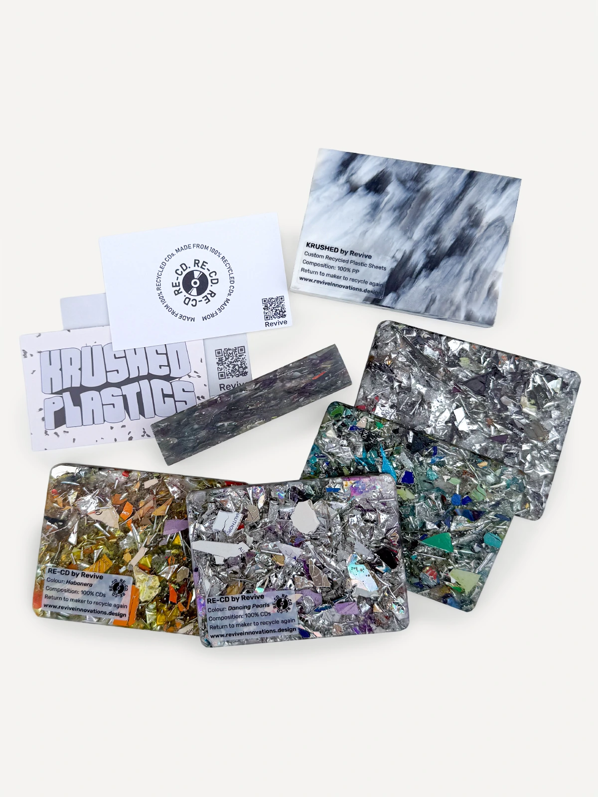 A curated pack of Revive Innovations RE-CD & KRUSHED material sample blocks showcasing various colorful recycled plastic surface finishes.