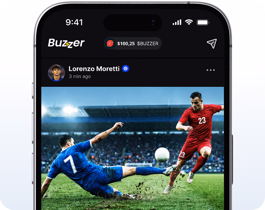 Soccer player in blue sliding to tackle a player in red on a grassy field in a stadium.