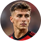 Close-up of a young man with curly hair wearing a red and black sports jersey.