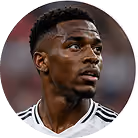 Close-up of a male soccer player in black and white jersey looking to his left.