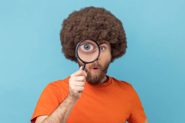 man posing with a magnifying glass 