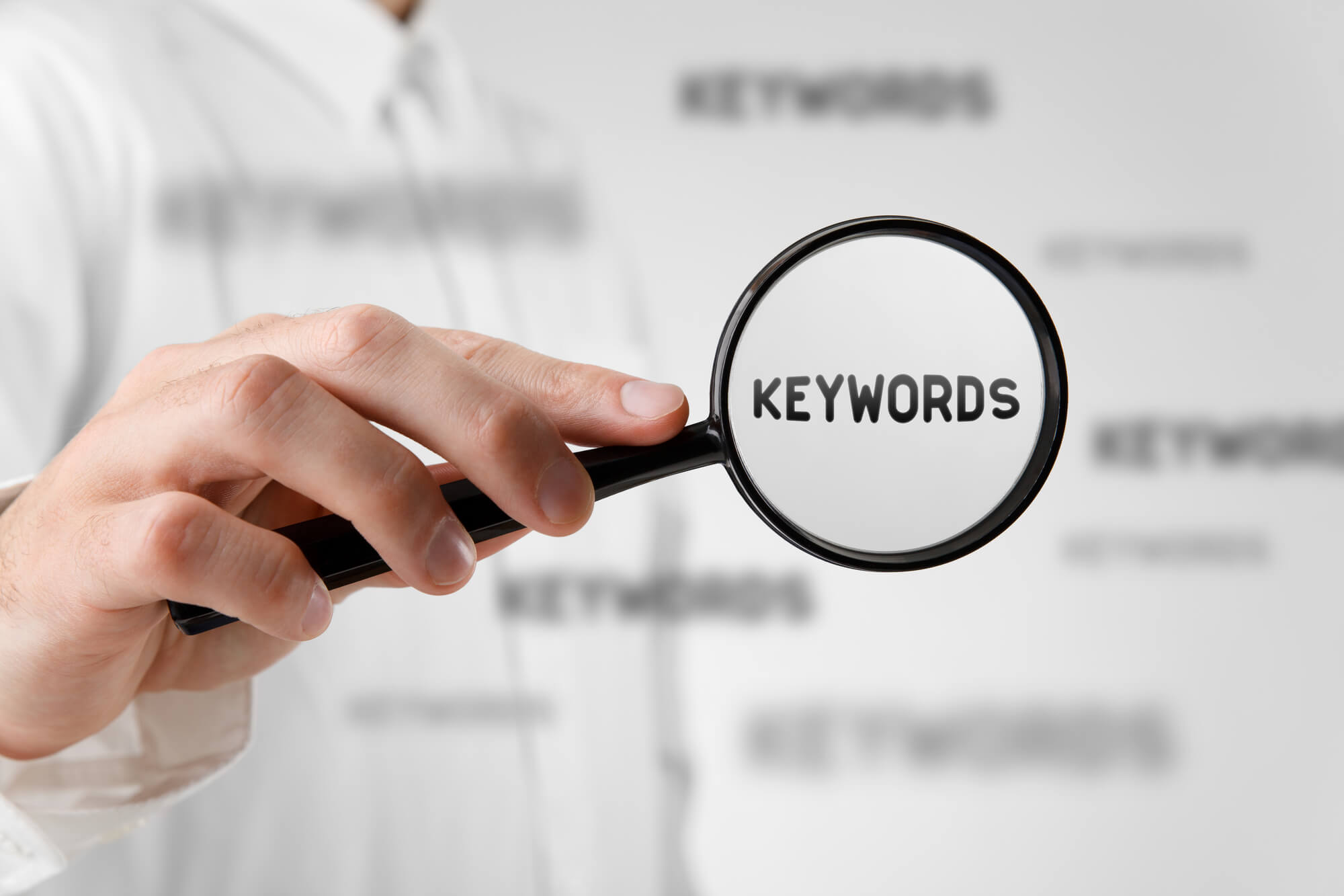 man looking for keywords with magnifying glass