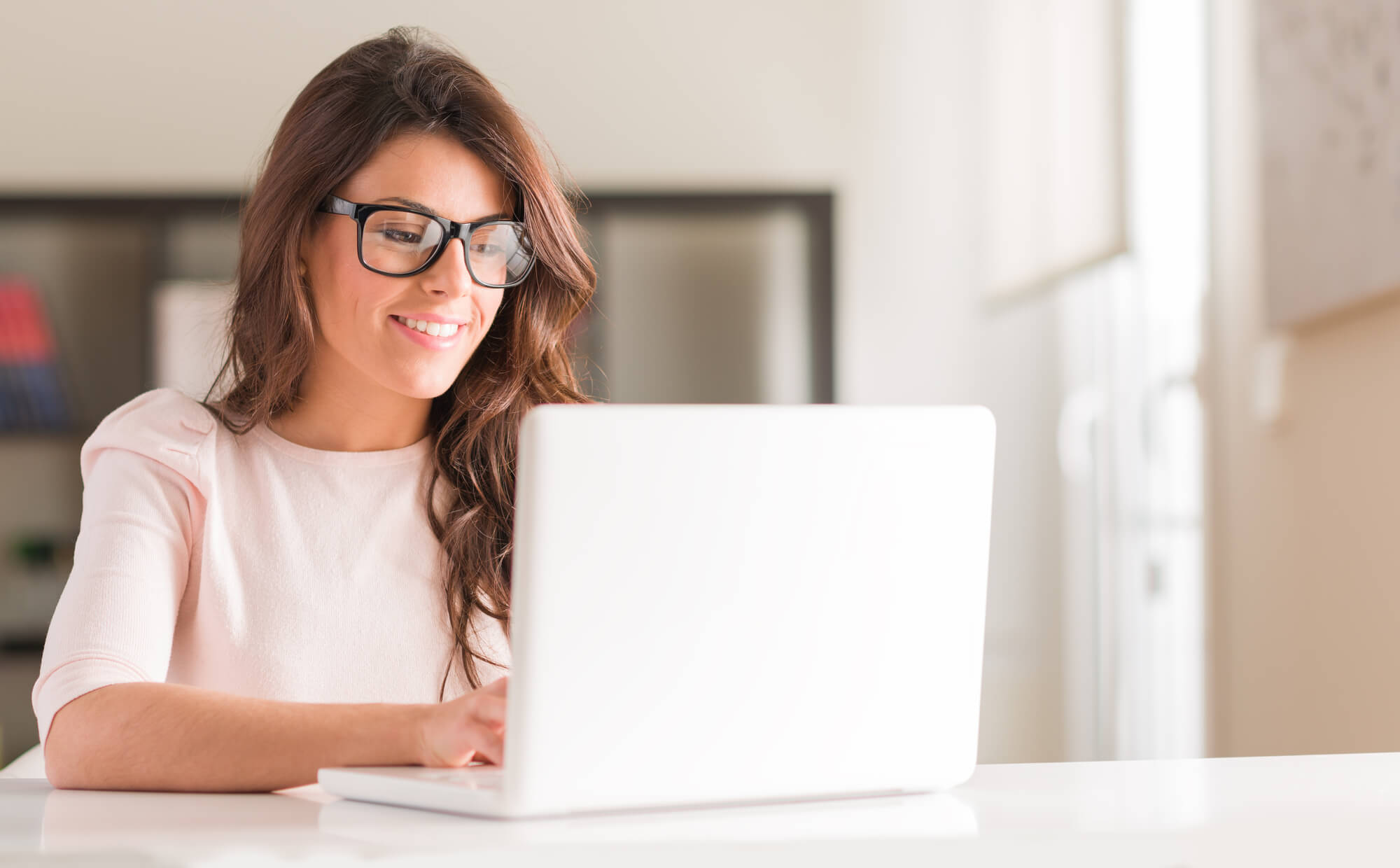 young woman smiling while reading email