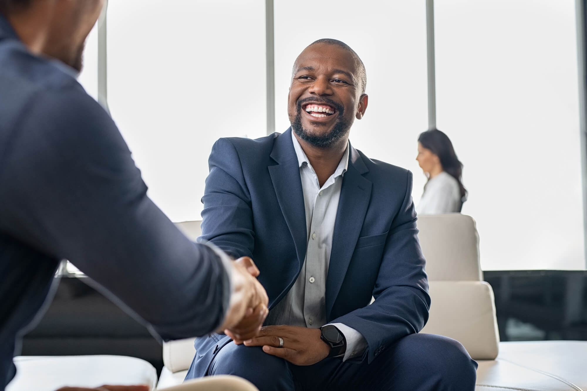 Business man happier after having a healthier mindset and slowly overcoming impostor syndrome. 