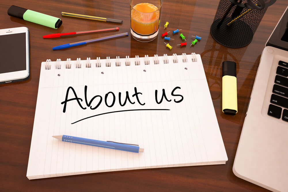 the word "about us" written on a pad paper