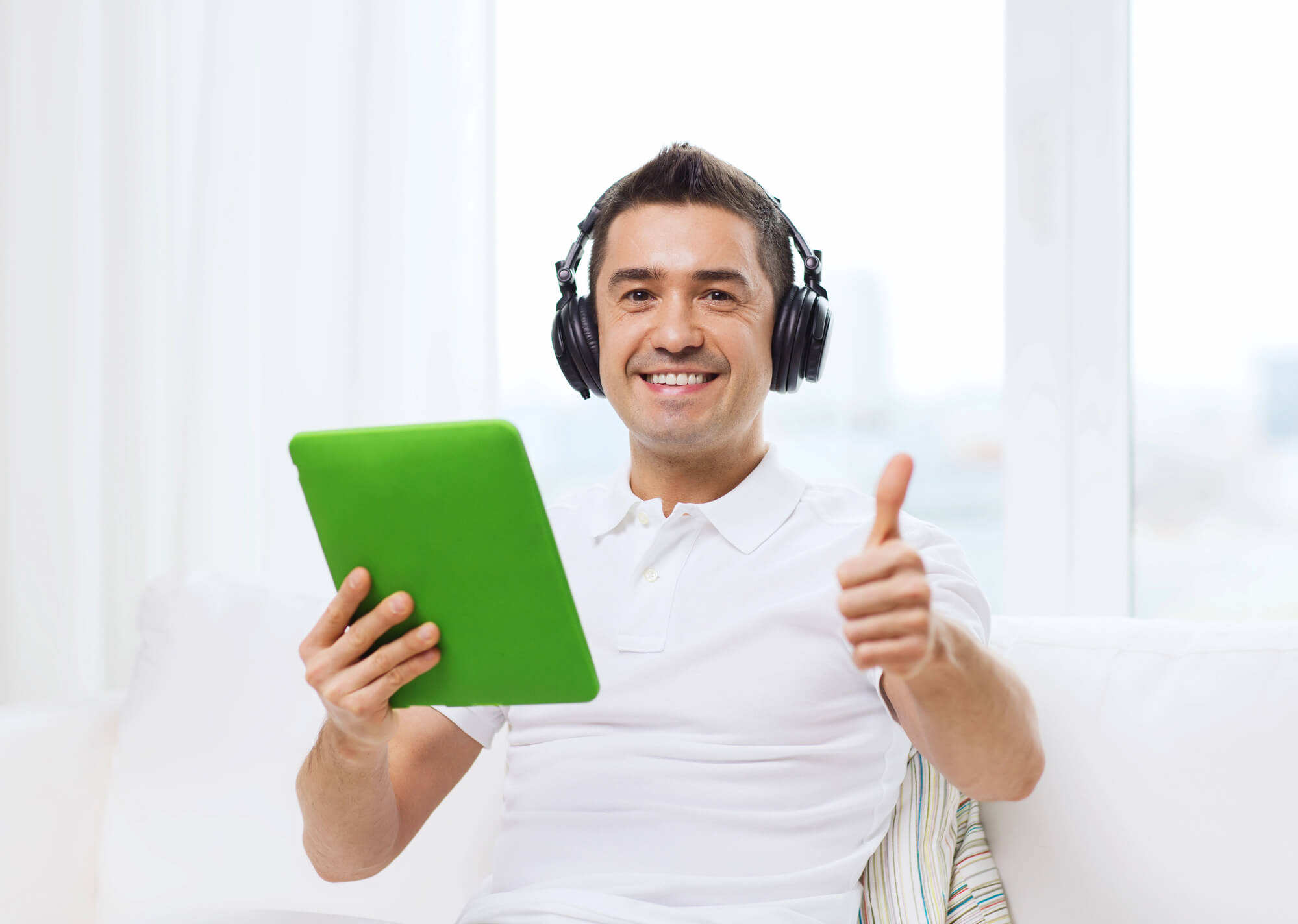 man listening to a podcast and giving a thumbs up