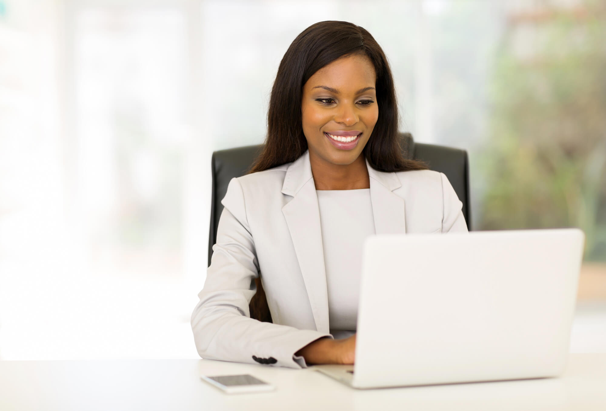 happy businesswoman working on her laptop 