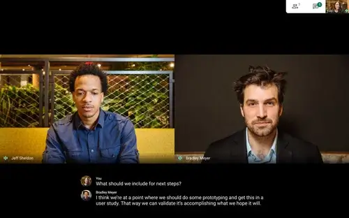 two men video calling on google meet with live captioning 