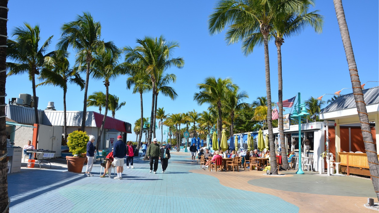 A vibrant shot of the charming shops, restaurants, and palm-lined streets to showcase the lifestyle.