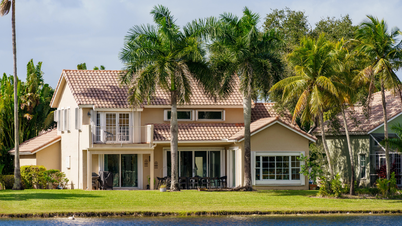 A modern home in Lakewood Ranch, FL, with a spacious yard and lush landscaping.