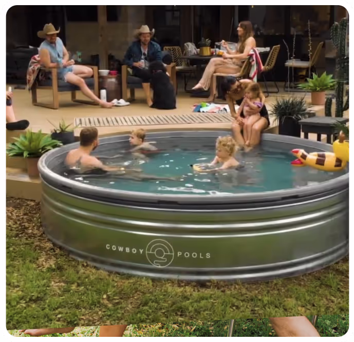 People sitting a stock tank pool in a backyard enjoying themselves.