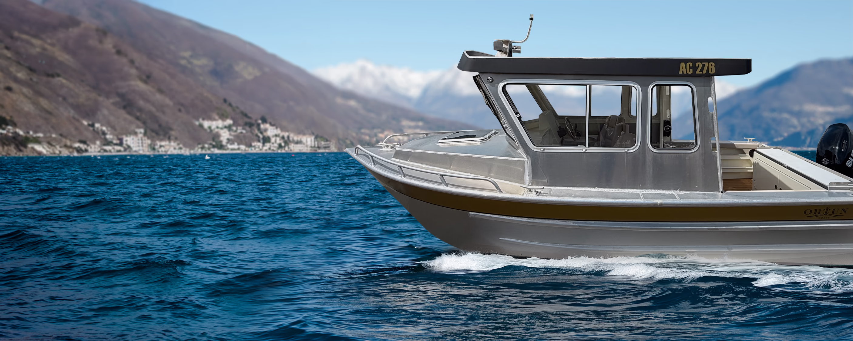 Ortun AC276 aluminum express cruiser hero photo with ocean and mountain backdrop, for sale by Whiskey Creek Marine.
