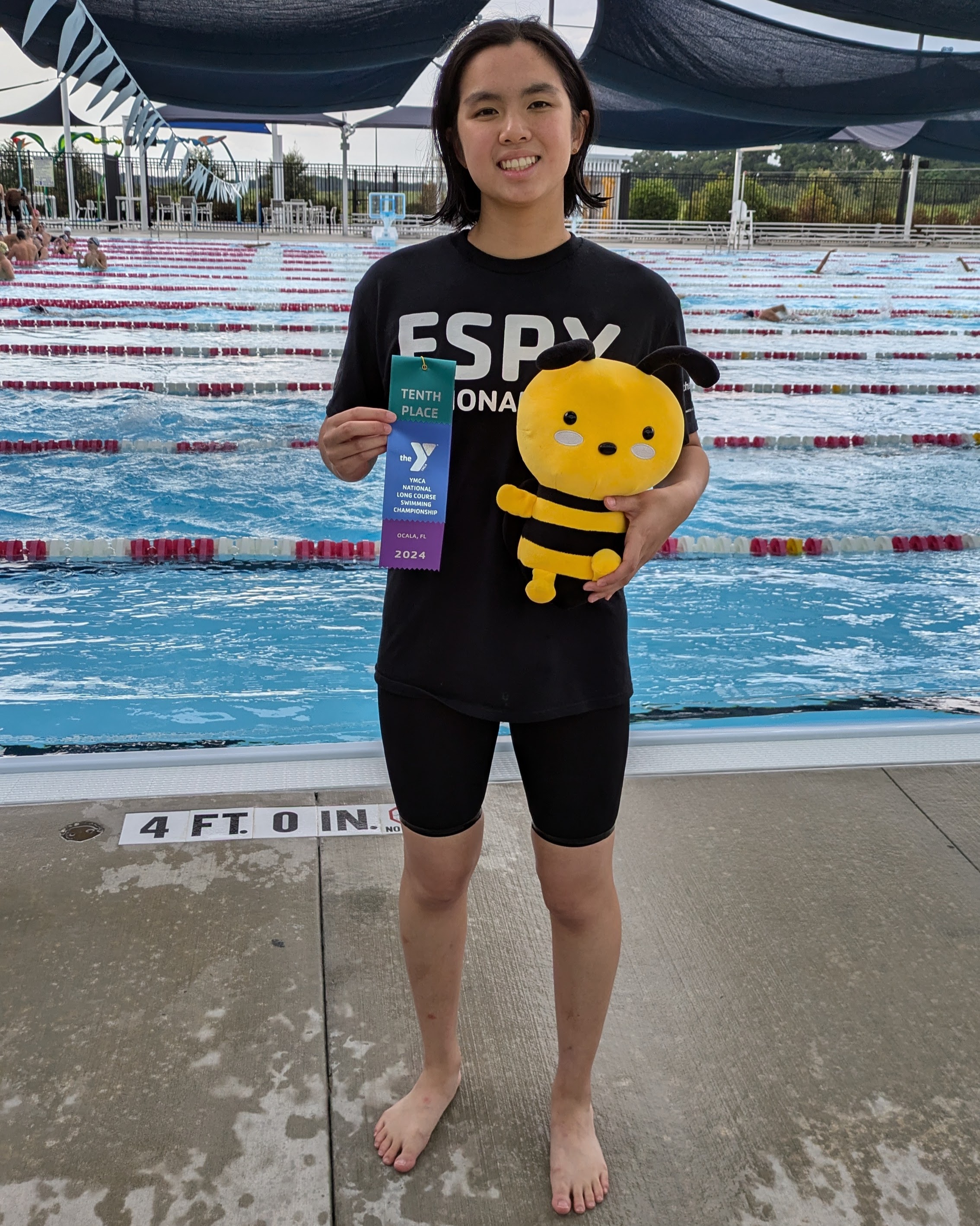 Victoria Gee at the 2024 YMCA Long Course Nationals with her ribbon