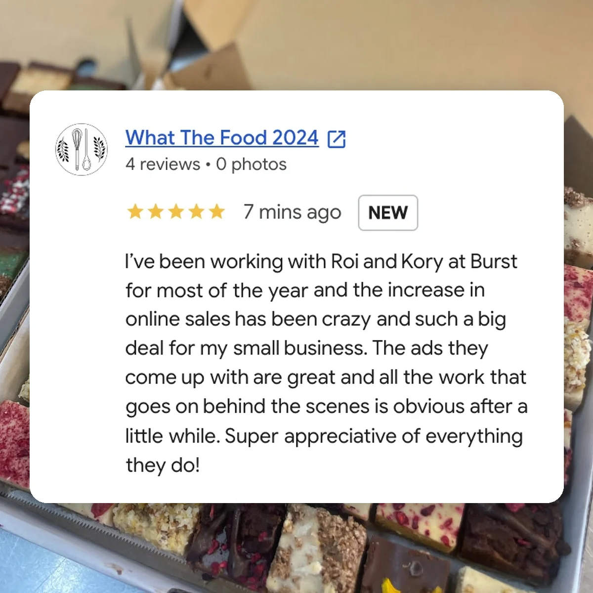 What The Food's 5 star Google review of Burst Digital, over a box of their treats