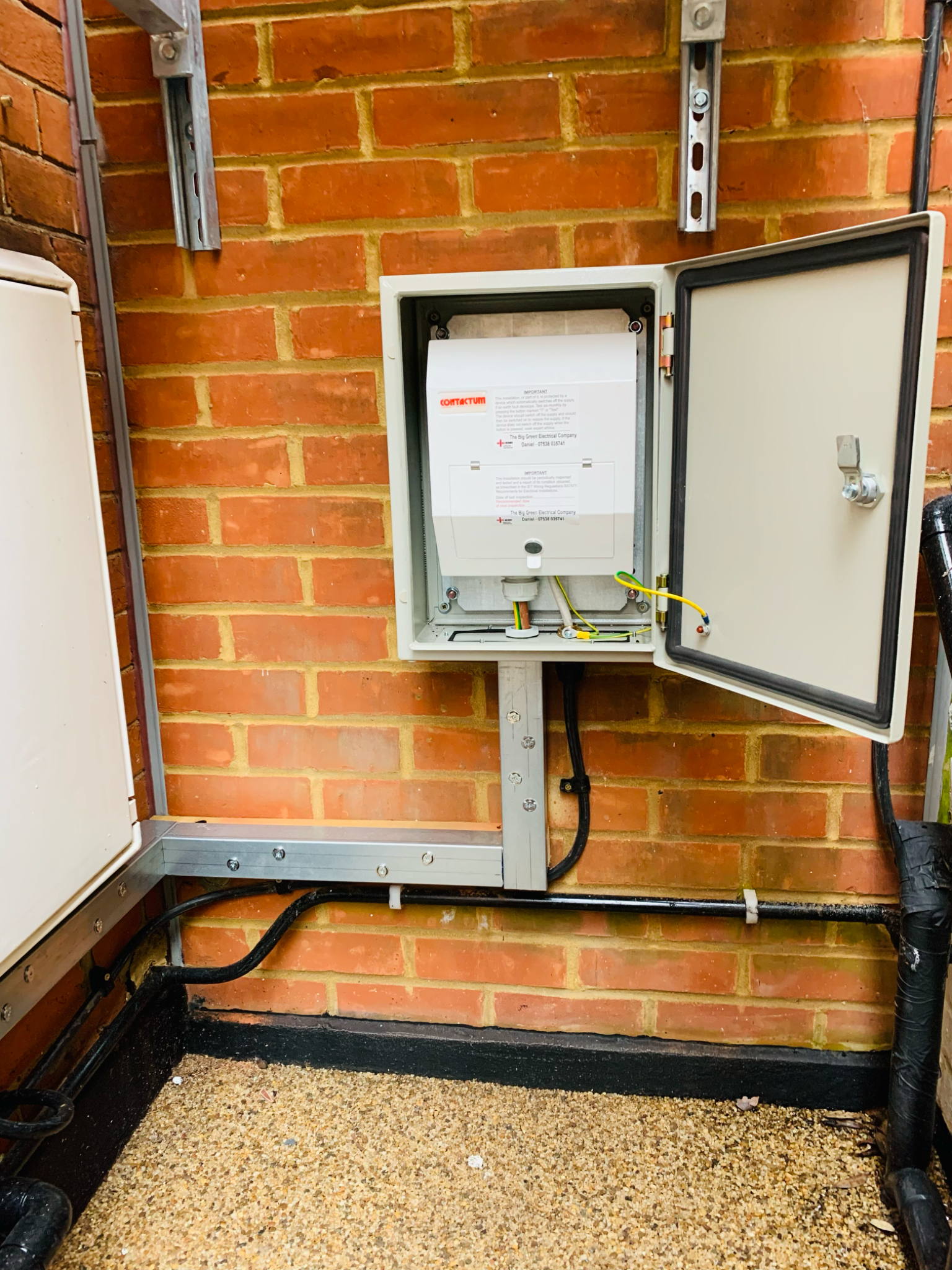 Consumer unit inside an IP-rated enclosure supplying an EV charger