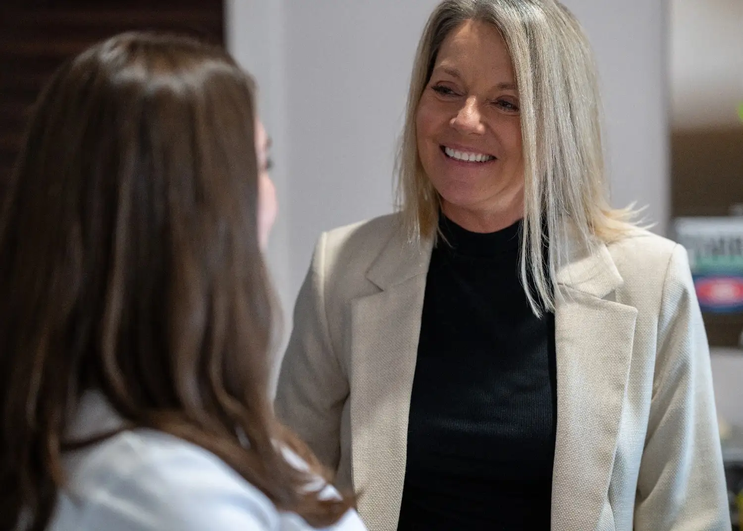 Image of a two lady smiling and talking with each other