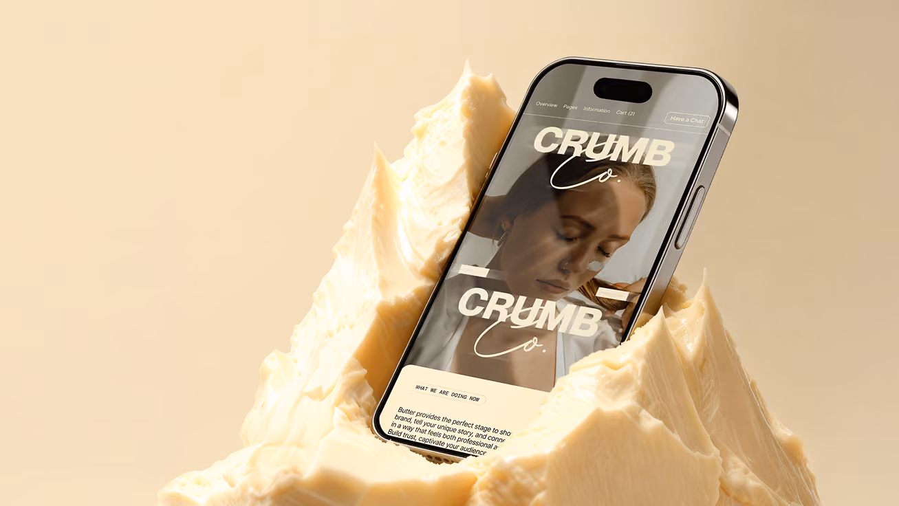 Smartphone mit geöffneter Webseite 'Butter Up' steckend in einem großen Stück Butter.