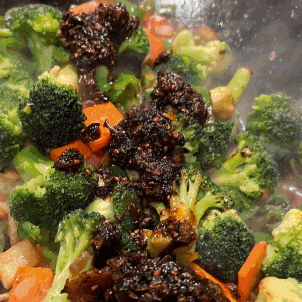 GIF showcasing Umami Everything 🌶️🍄 drizzled over stir-fry, pizza, sandwiches, and fries, alongside Umami Gyoza 🥟—bold Japanese flavors for every dish.